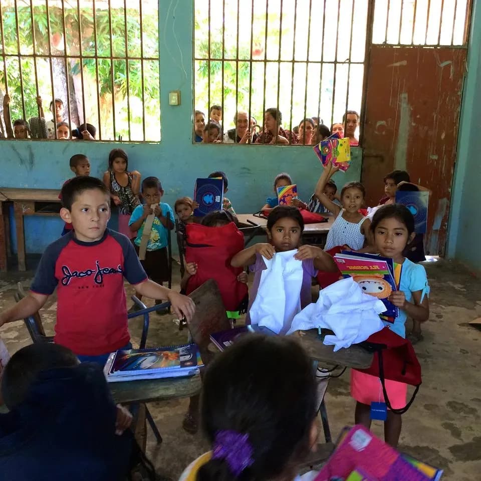 children receiving school supplies